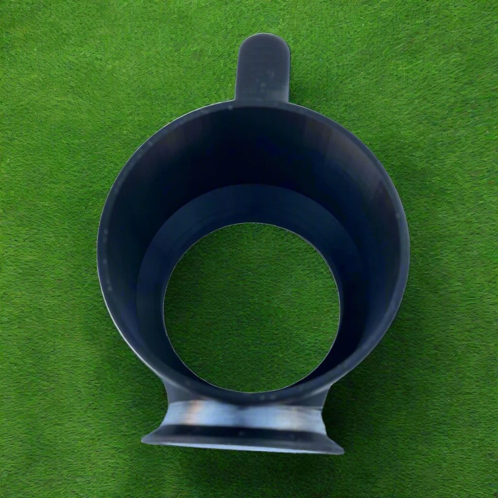 A top view of a Chill-N-Reel® Tumbler Handle (Prototype) with a sleek black design, resting on a green grass-like surface, ideal for fishing enthusiasts who value style in their outdoor gear, paired with a 30oz tumbler.