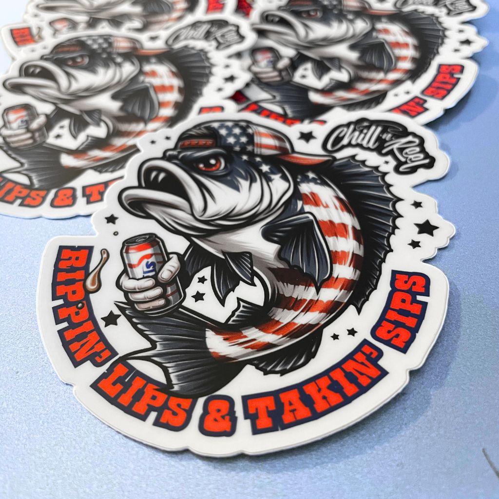 Stickers featuring a cartoon fish wearing an American flag-patterned cap and holding a drink can. The vinyl sticker design includes the text "Rippin' Lips & Takin' Sips" in bold, stylized font. Some stickers are slightly overlapping each other on a light blue surface, perfect for Rippin' Lips & Takin' Sips Redneck Fish Vinyl Sticker (Chill-N-Reel not included) fans from Chill-N-Reel.