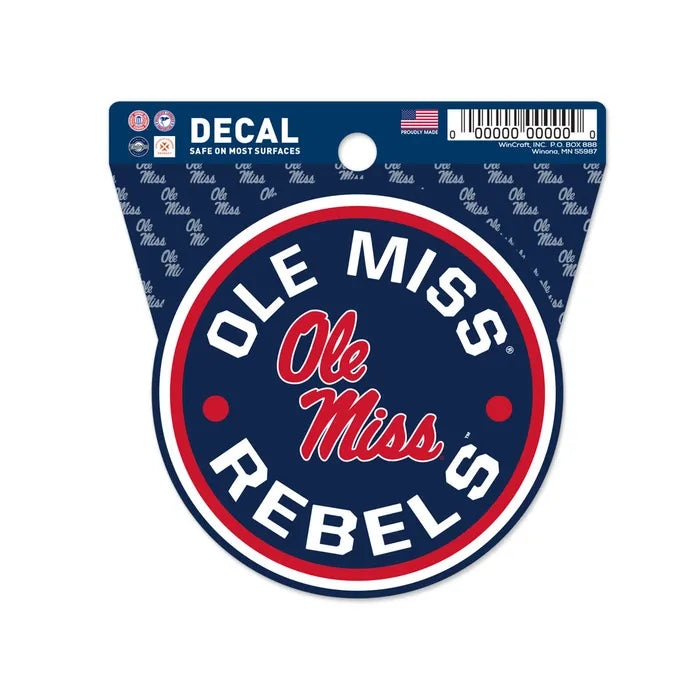 The Chill-N-Reel® Official NCAA Vinyl Decal Sticker, 3.5” round, displays "Ole Miss Rebels" on the border and "Ole Miss" in script at the center with blue, red, and white colors. It comes in official packaging with repeating "Ole Miss" text.