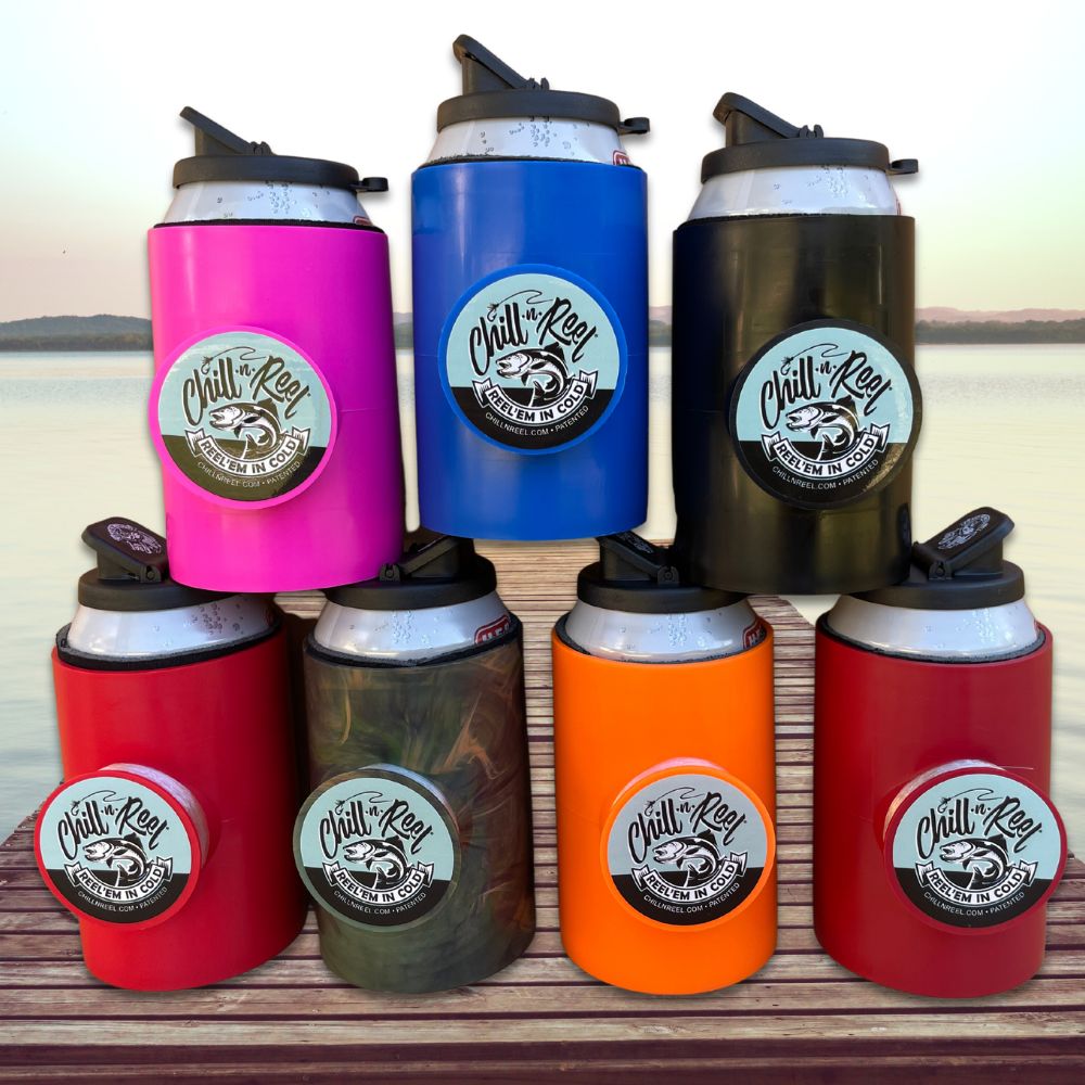 A group of seven Original Chill-N-Reel can coolers with Spill Guard from Chill-N-Reel, a clever Shark Tank product, are displayed on a wooden dock with water and landscape in the background. The holders are colored pink, blue, black, red, camo, orange, and crimson—each featuring a fishing reel and line attached to the side. A fun fishing gift!