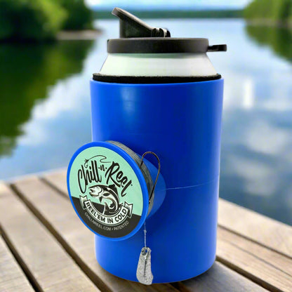 The Original Chill-N-Reel by Chill-N-Reel, a blue can cooler with a hand-line fishing reel, rests on a wooden surface by a lake with trees and water in the background.
