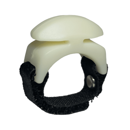 The Line Cutterz Ceramic Blade Ring by Line Cutterz is a white plastic fishing line cutter with a curved top, mounted on a black adjustable fabric strap with a metal snap, displayed against a plain white background.
