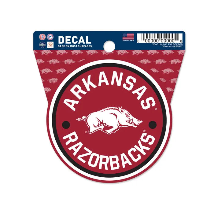 The Chill-N-Reel® Official NCAA Vinyl Decal Sticker is a 3.5” round decal featuring a white razorback hog on a red background with "Arkansas Razorbacks" in bold white letters, officially licensed and packaged with blue top labeling.